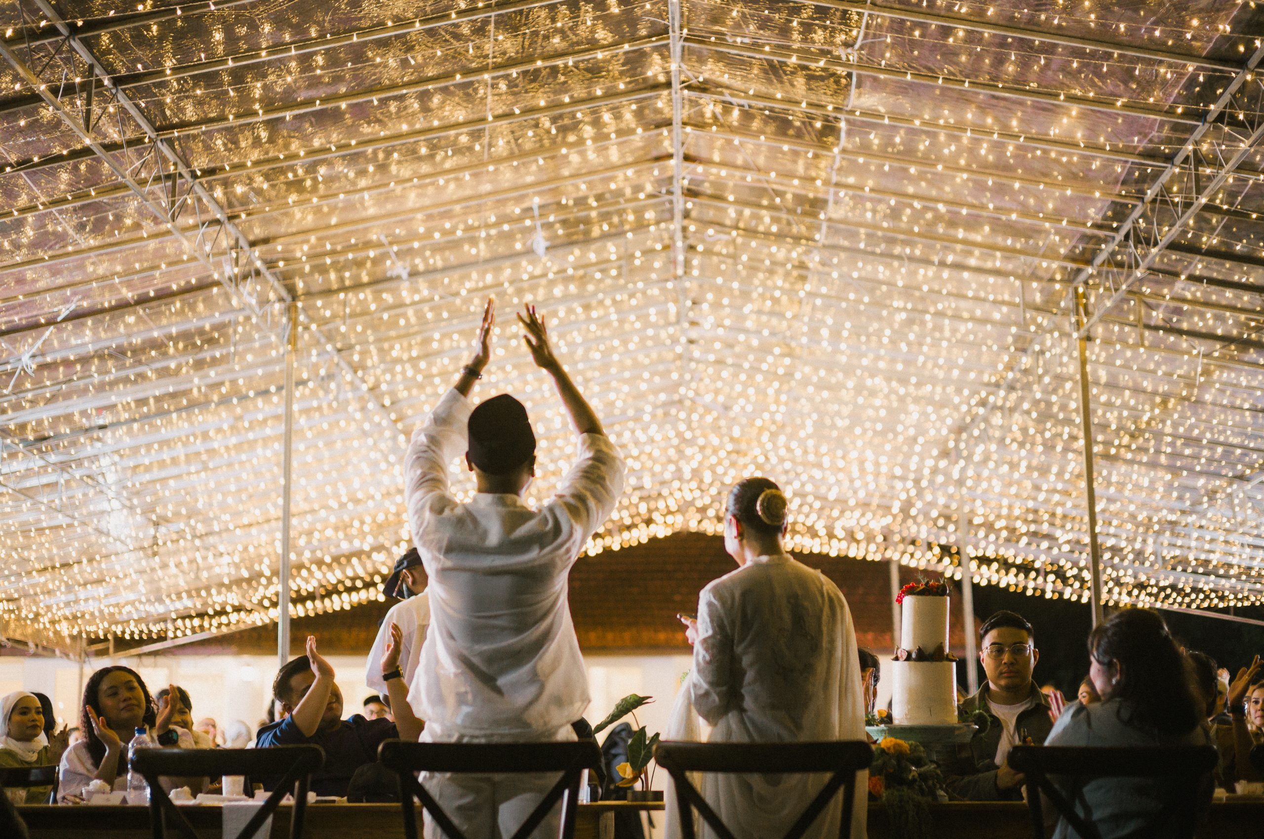 Guests celebrating beneath warm event lighting